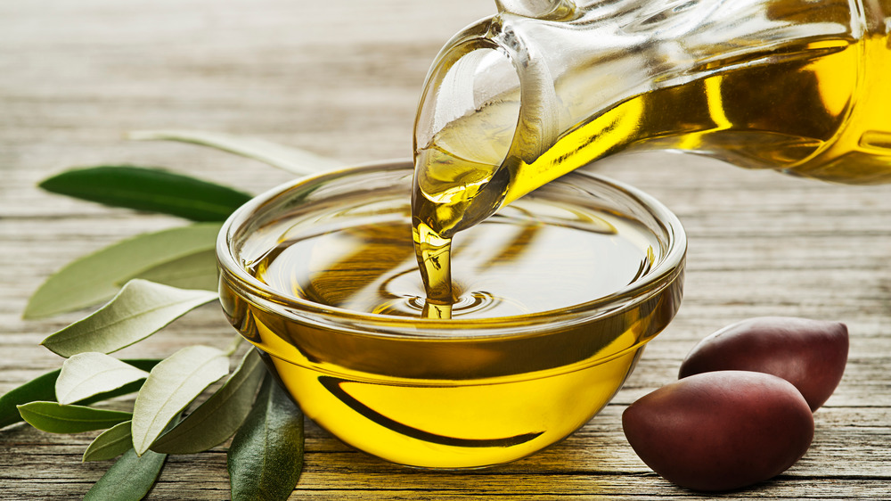 pouring olive oil in bowl