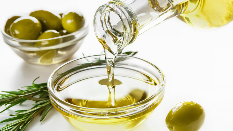 pouring olive oil into a bowl