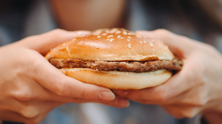 Person holding hamburger