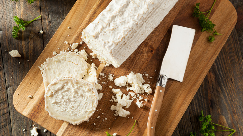 Goat cheese on a wooden cutting board