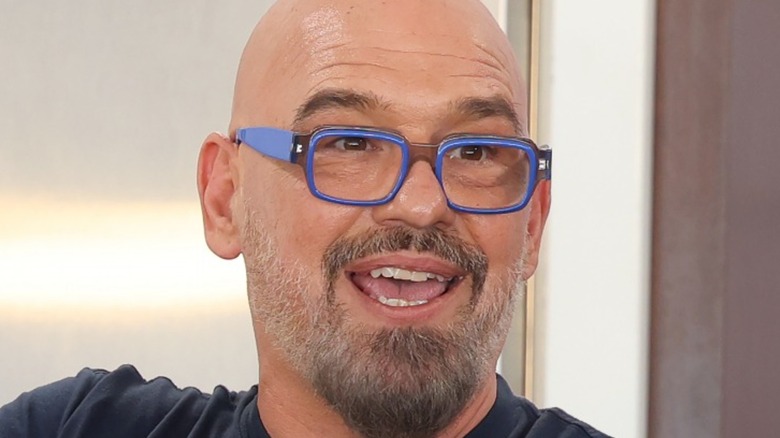 Michael Symon wearing glasses and mouth open