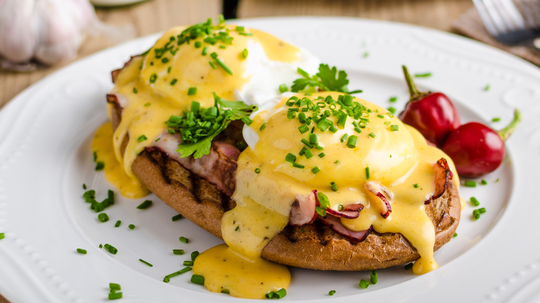 Thick yellow Hollandaise sauce over poached eggs and bread.