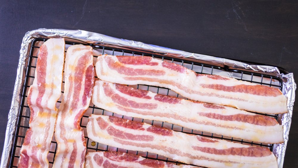 raw bacon on baking sheet