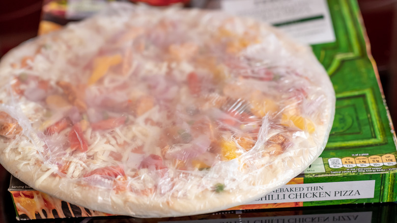 frozen pizza wrapped in plastic