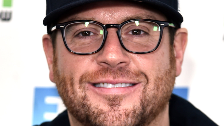 Close up of Scott Conant wearing a Giants hat, glasses and smiling