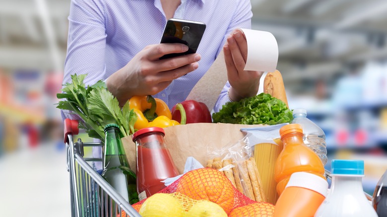Woman loading grocery cart