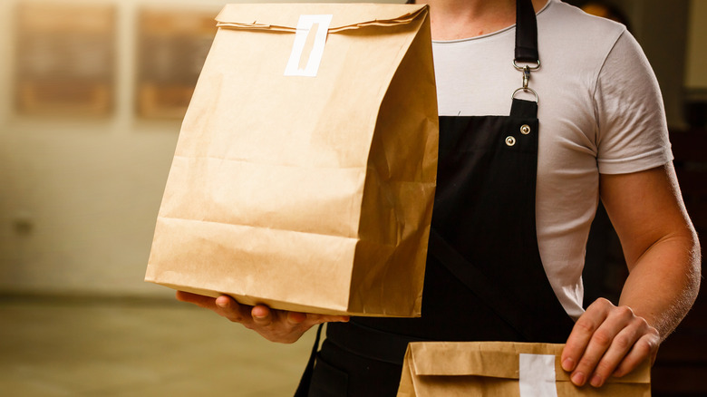 Person delivering bags of fast food