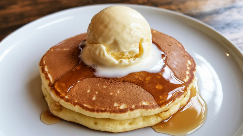 A plate of pancakes with butter melting on top