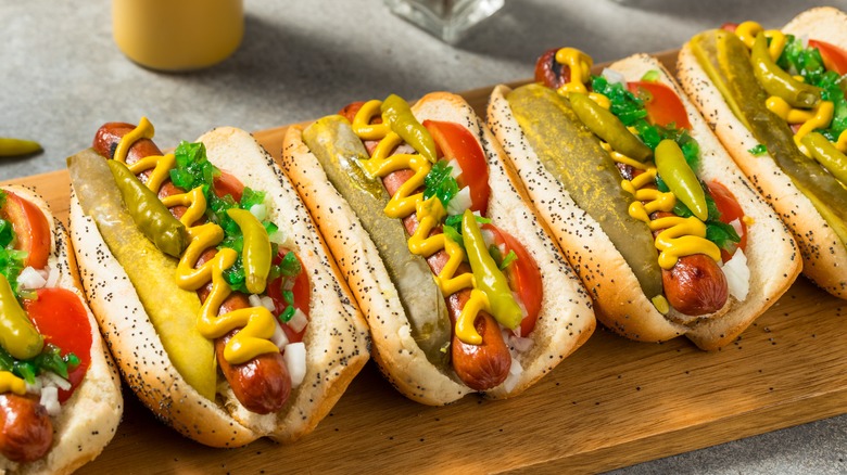 Chicago-style hot dogs on wooden cutting board