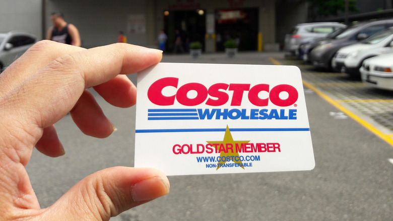 Hand holding Costco membership card