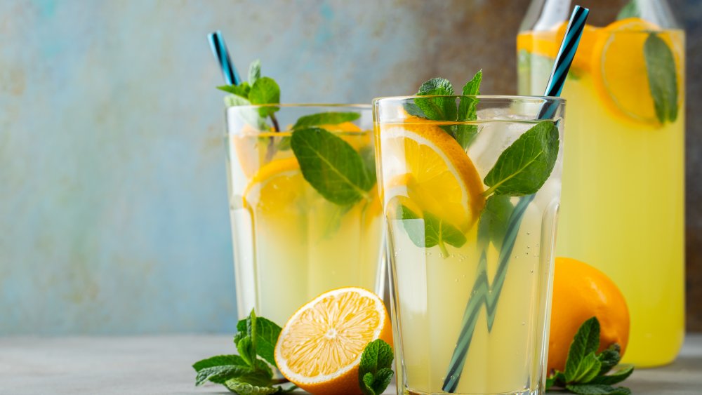 fresh lemonade in two glasses and a pitcher