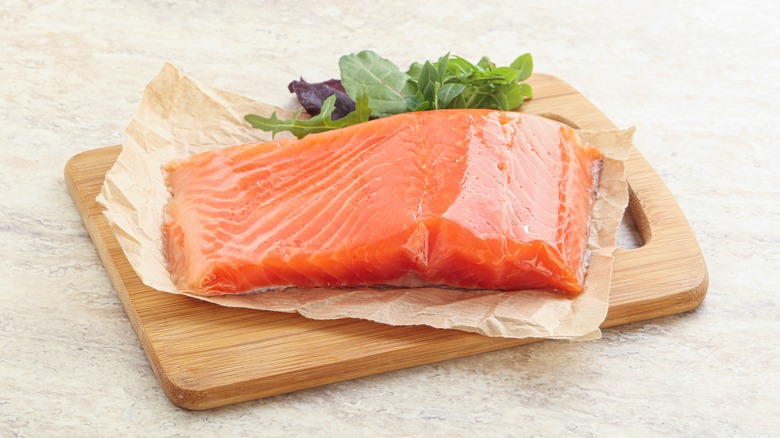 Salmon fillet on cutting board