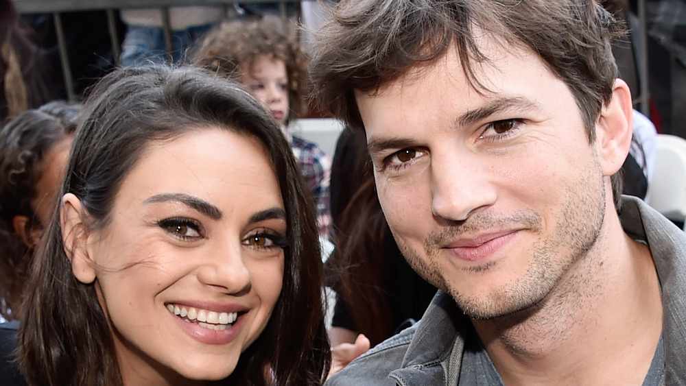 Mila Kunis and Ashton Kutcher posing