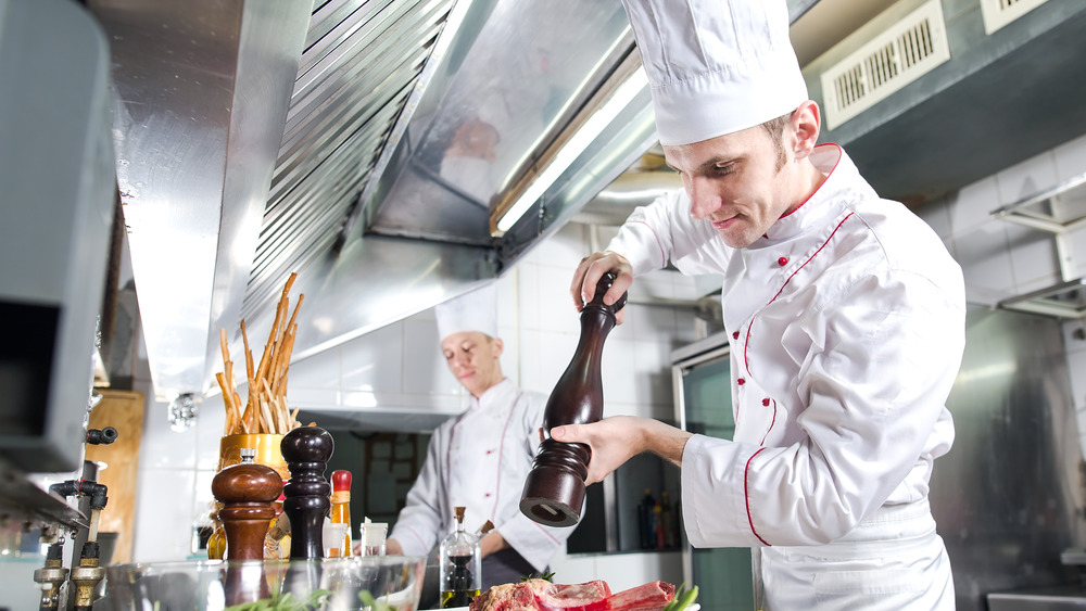 Chef holding pepper grinder