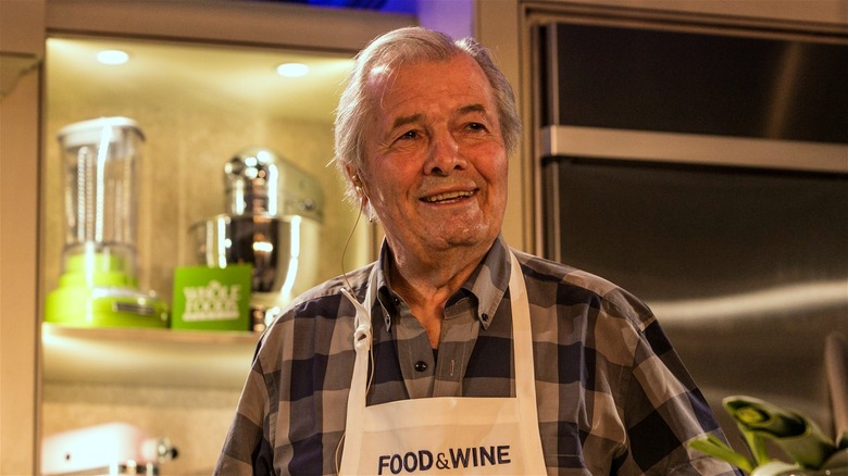 Jacques Pépin onstage giving a live cooking demonstration.