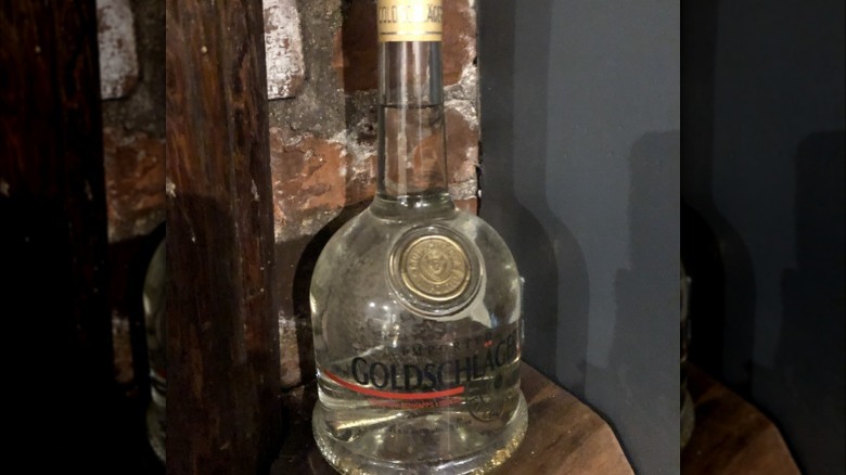 Dusty Goldschlager bottle on table