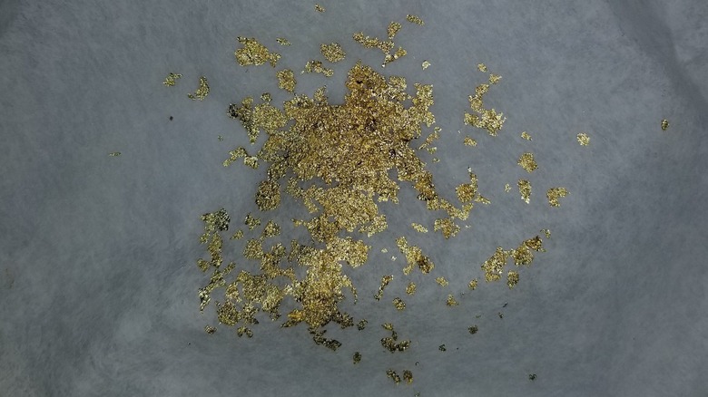 Gold flakes strained from Goldschlager bottle