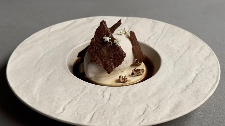 Scoop of ice cream with ingredient toppings on a gray plate from Minimal in Taiwan