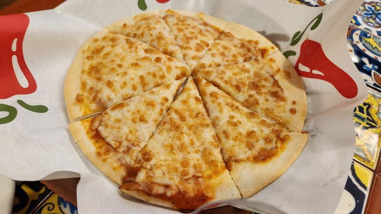 A Chili's pizza on a white cloth with the restaurant's logo