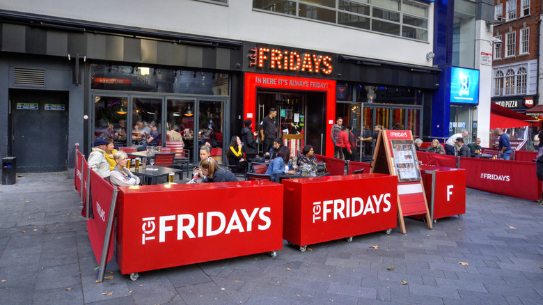 People dining outside a TGI Fridays location in London