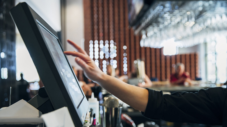 A server using a POS machine