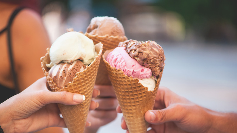 people holding ice cream cones