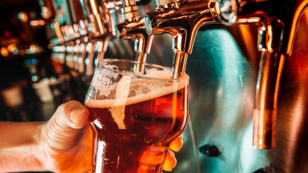 Bartender pouring a beer from the tap