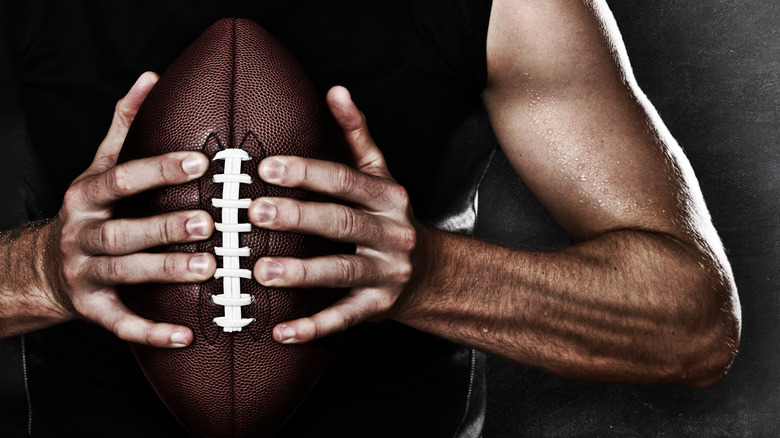 man holding football