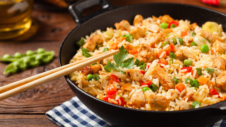A pan of fried rice with chopsticks
