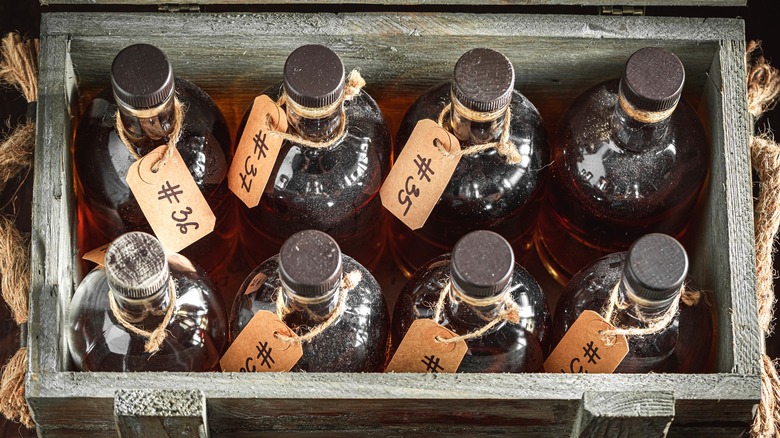 craft whiskey bottles in a wooden storage box