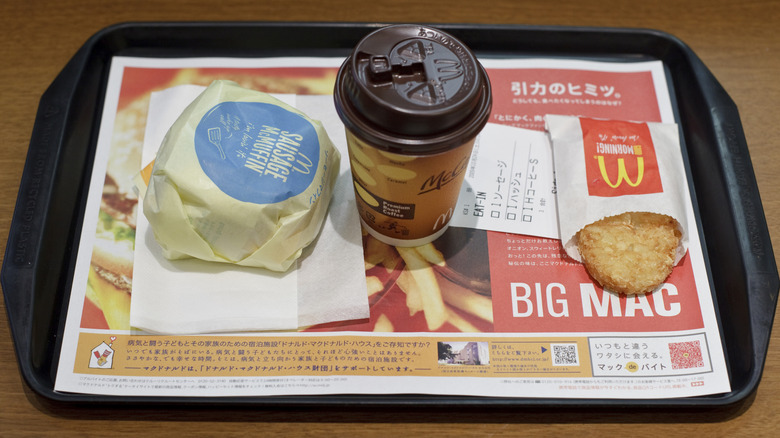 McDonald's tay with wrapped McMuffin, lidded coffee cup, and bagged hashbrown patty