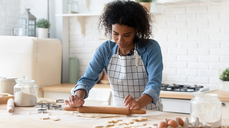 Woman rolls out cookie dough