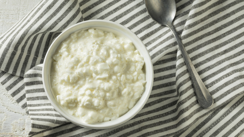 Bowl of cottage cheese with a spoon.
