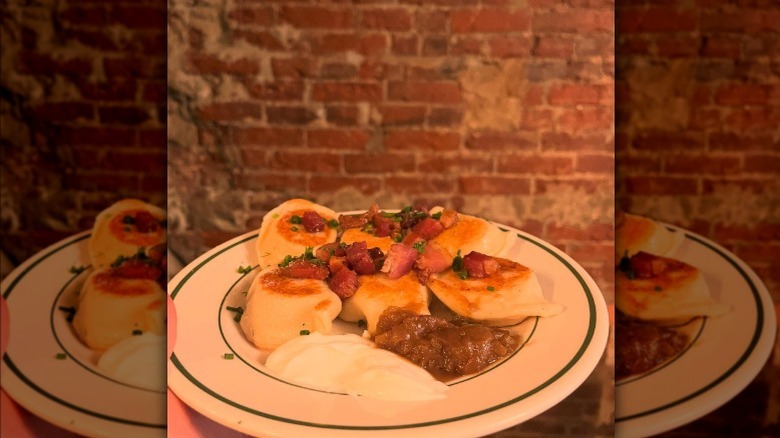 Plate of pierogis with applesauce and sour cream