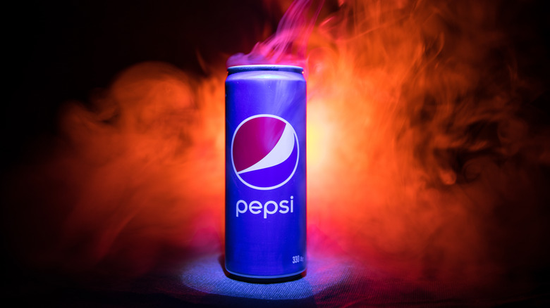 can of Pepsi in front of smoke