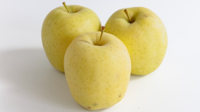 Three Golden Delicious apples