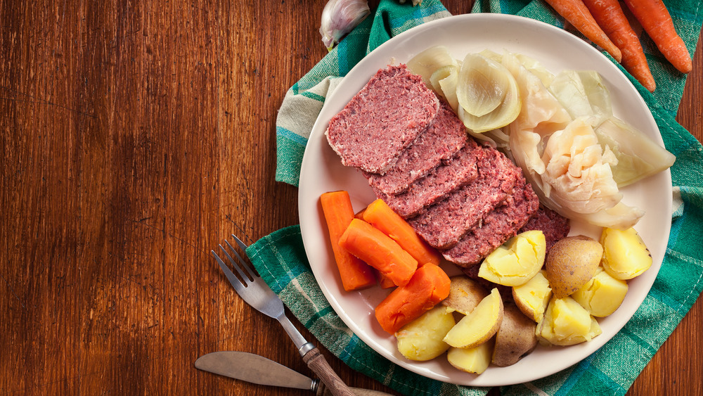 Corned beef and cabbage on wooden table