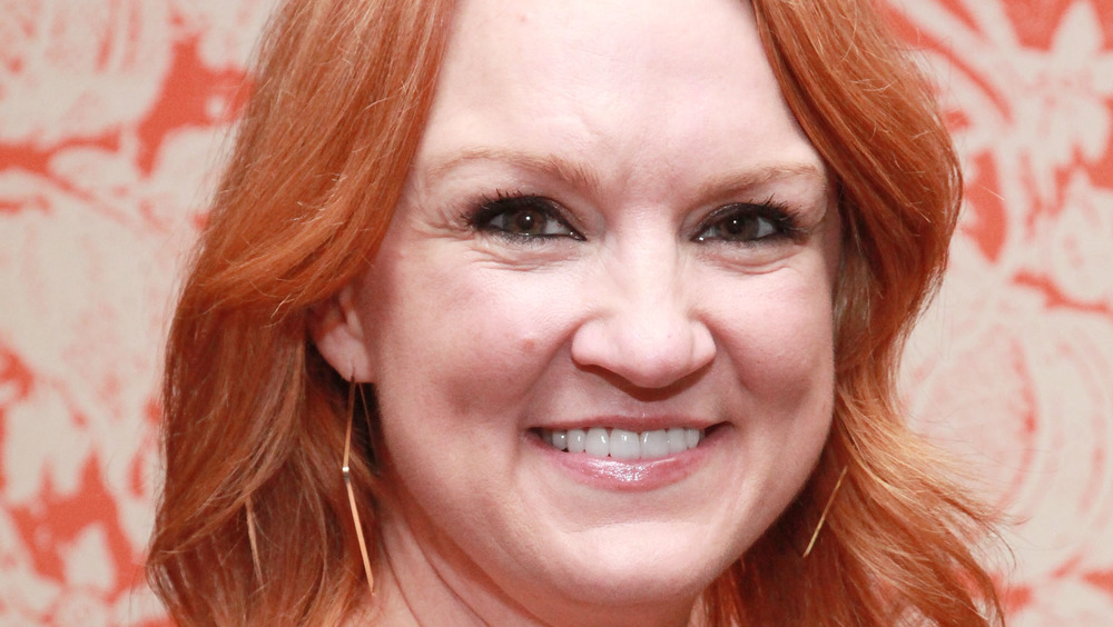 Ree Drummond smiling with a red background