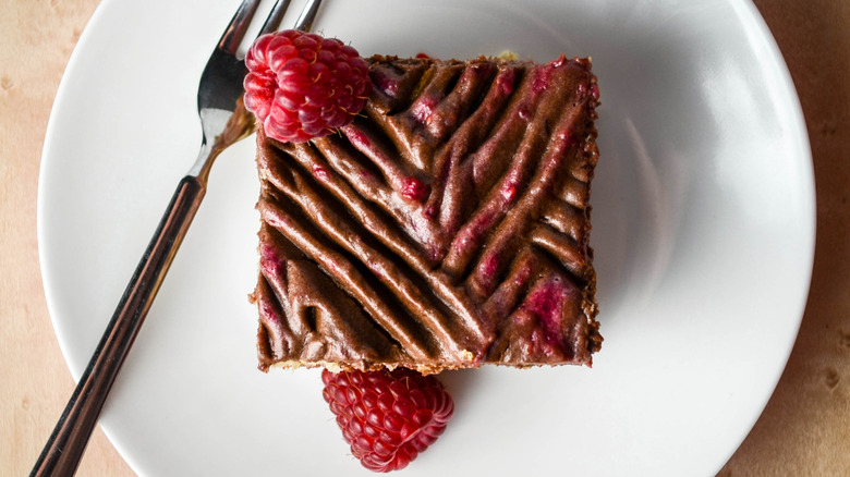 Chocolate raspberry icebox cake on white plate
