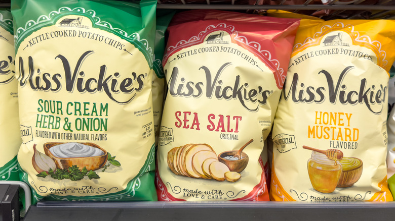 Three bags of Miss Vickie's potato chips on a store shelf