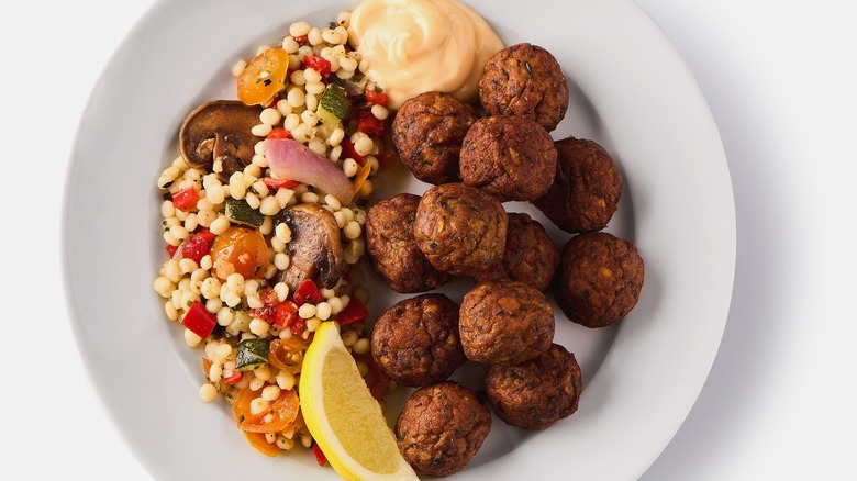 Ikea falafels served with vegetable couscous, lemon, and aioli