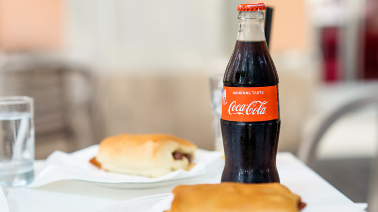 Vintage bottle of Coca-Cola with sandwiches