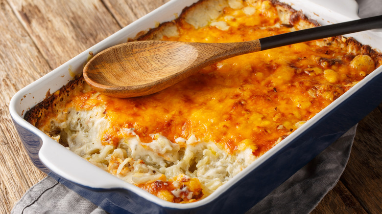 Cheesy potato casserole with spoon