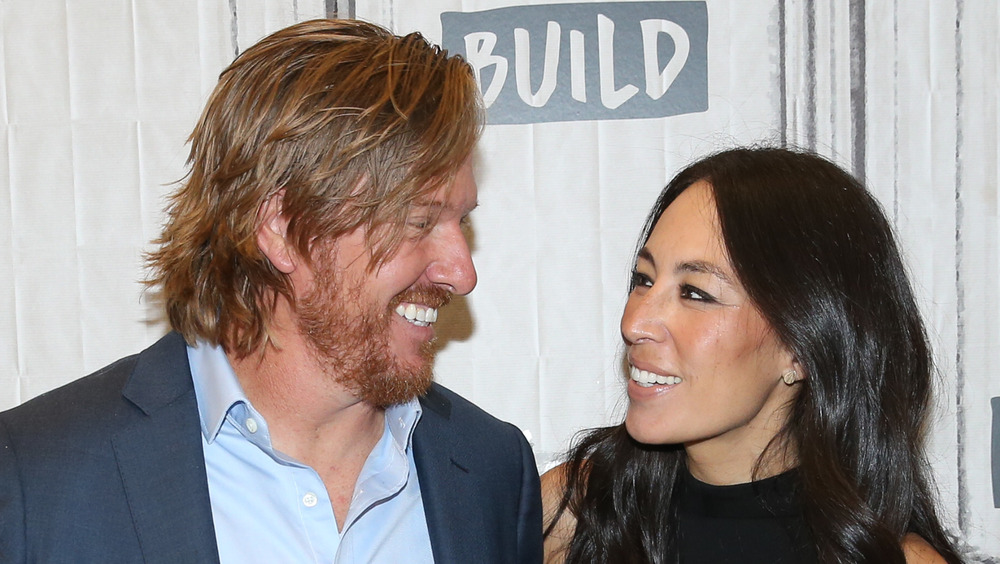 Chip and Joanna Gaines smiling at each other