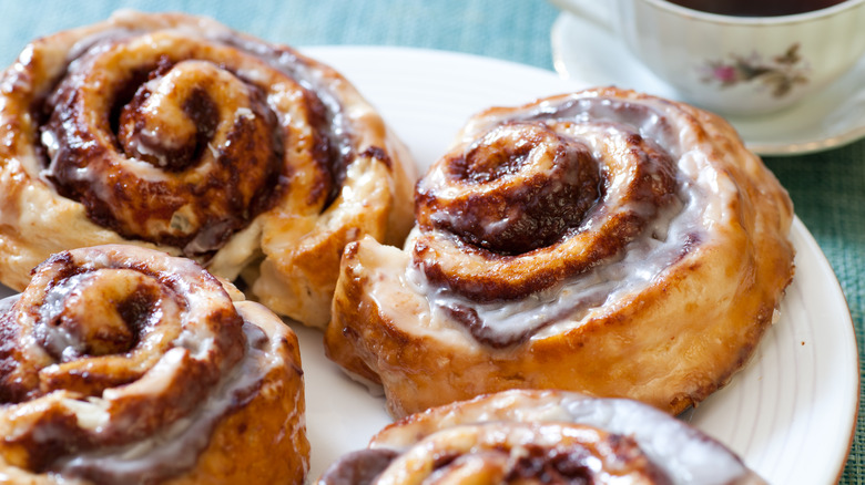 Cinnamon rolls on plate with cup of coffee
