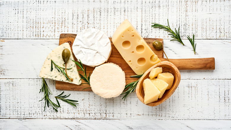 Assortment of cheeses on a wooden board