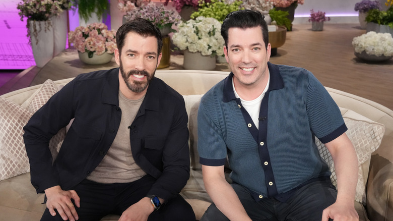 Property Brothers sitting on a couch for an interview