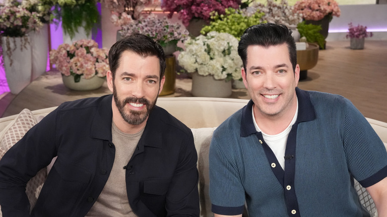 The property brothers sitting on a couch for morning TV