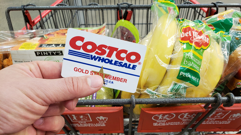 a person holding at a costco card