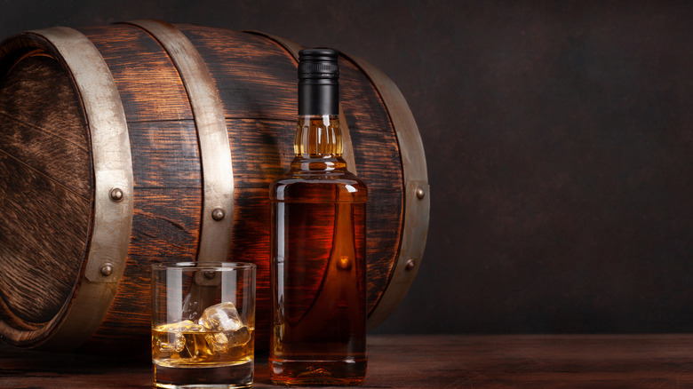 Bourbon barrel, glass and bottle